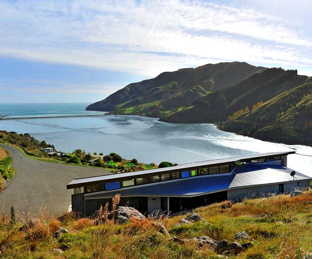 Aerial view of house from behind with sea view of cable bay